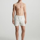 Thumbnail of calvin-klein-med-drawstring-tape-logo-swim-shorts---chalk_562750.jpg